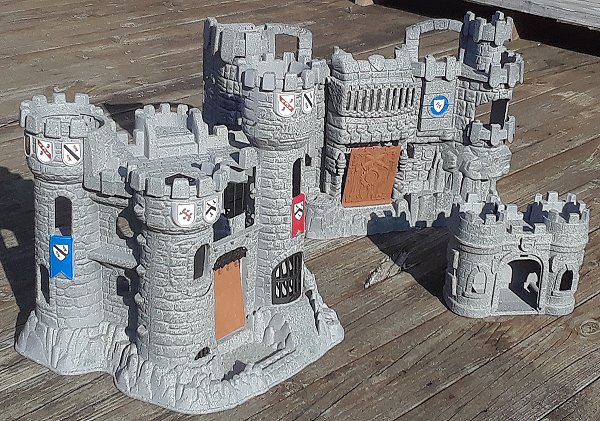 Three Fisher Price castles painted with simulated stone paint and adorned with custom stickers.  Click for bigger photo.
