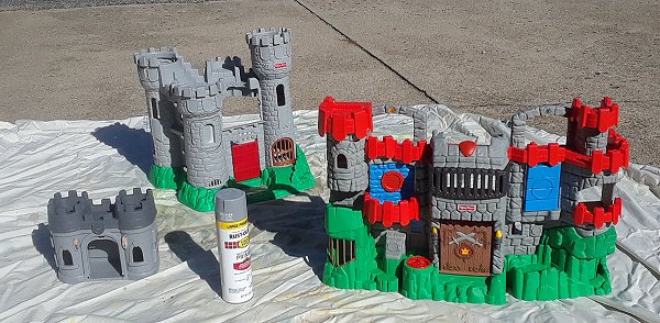 Three thrift-shopped Fisher Price castles with the stickers removed ready for painting. Click for bigger photo.
