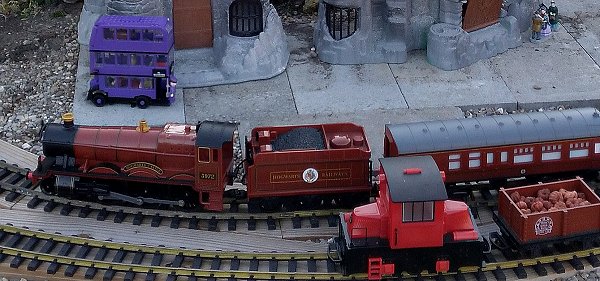 The Lego Knight Bus on our outdoor railroad, near Lionel's battery-powered Hogwarts' Express.  Click for bigger photo.